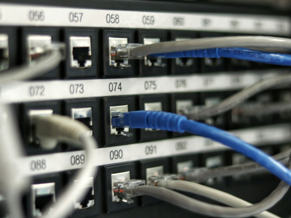 Network patch panel with cables being re-routed